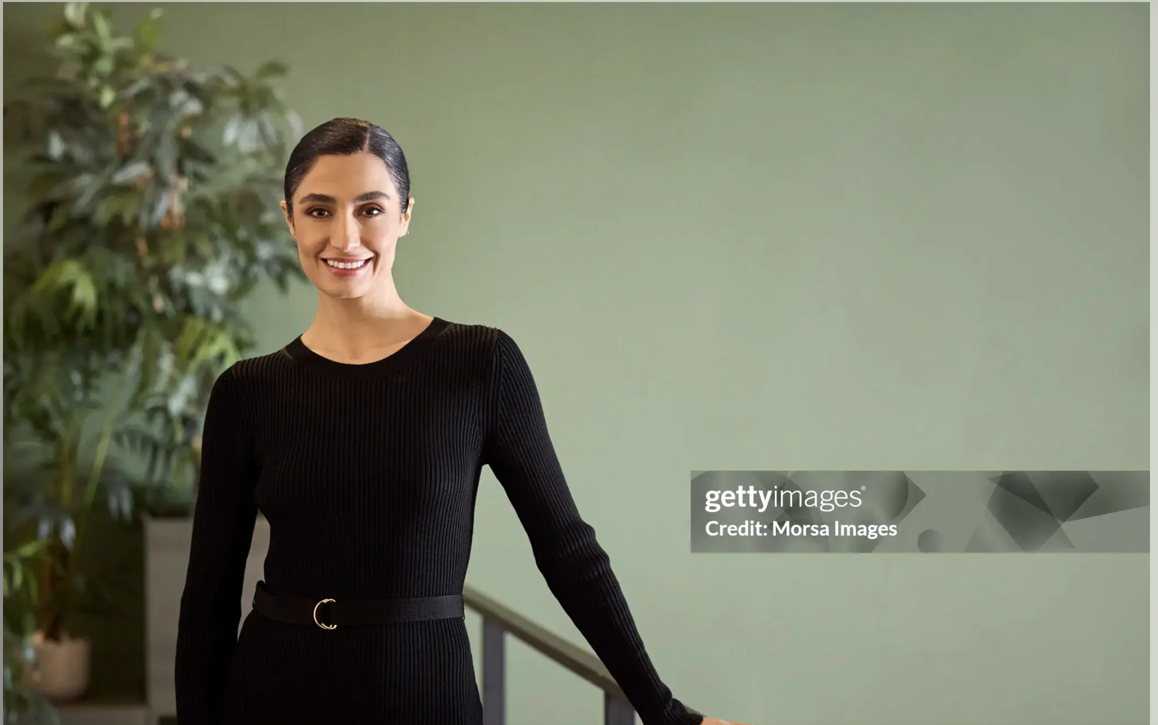 Confident Professional Woman Portrait with Sage Green Background