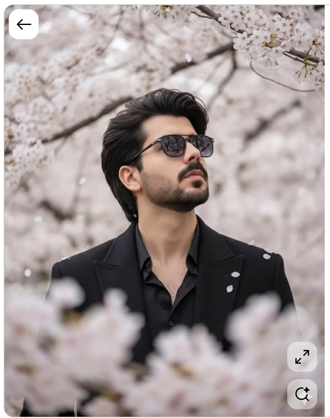Stylish Man in Black Suit Amid Cherry Blossoms